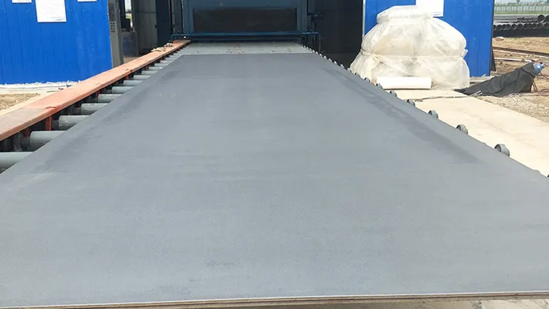 High-volume continuous roller conveyor shot blasting result on standard steel plate showing Sa2.5 cleanliness and uniform surface profile