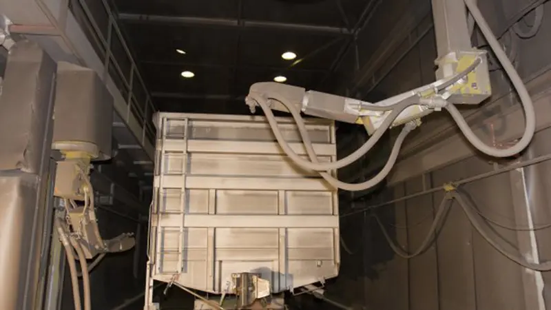 Interior view of train blast chamber featuring heavy-duty manganese steel liners and multi-wheel blasting structures.